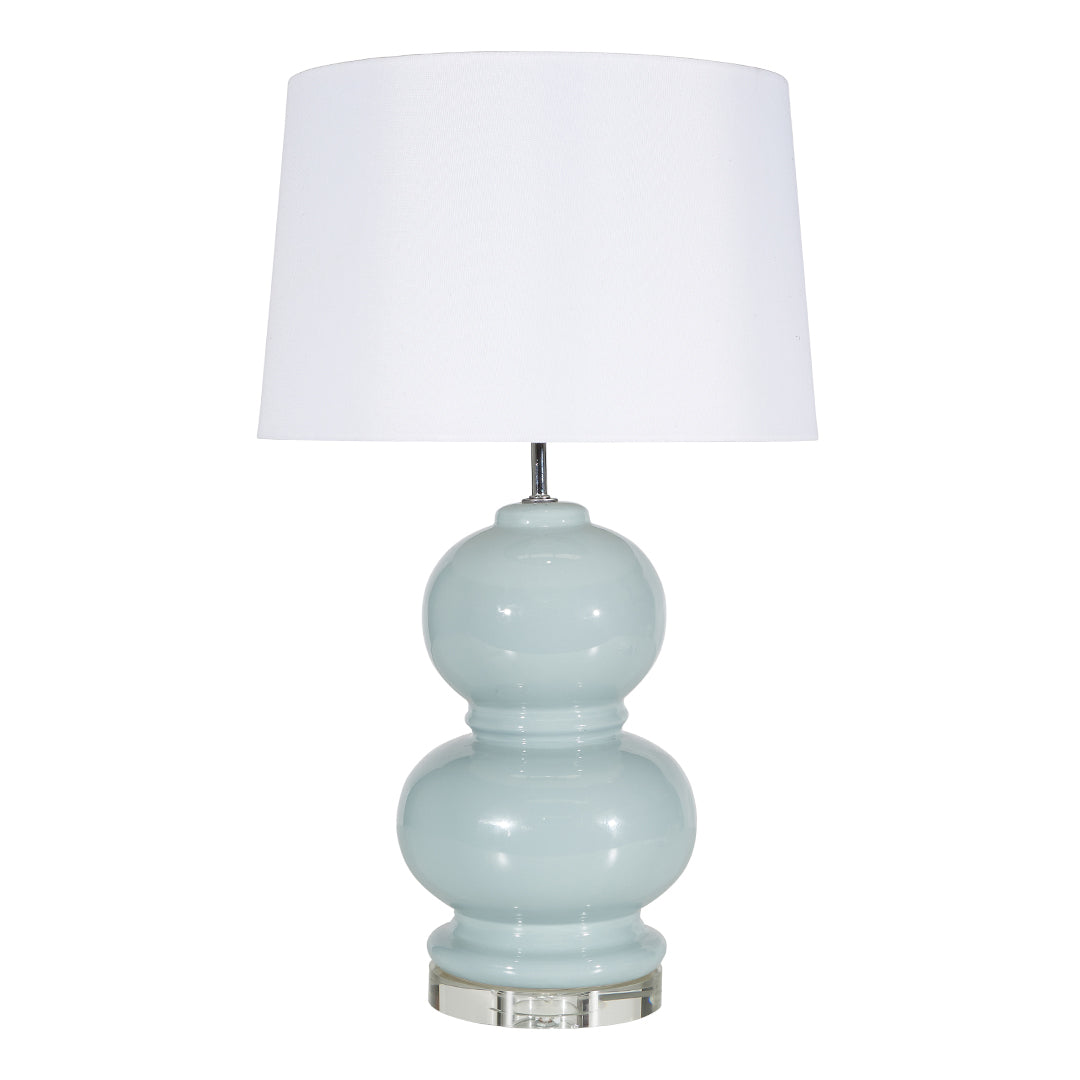 Light blue ceramic lamp with white shade on white background