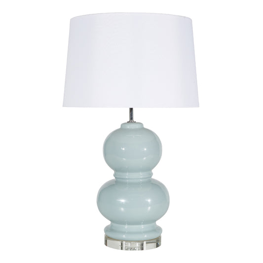 Light blue ceramic lamp with white shade on white background