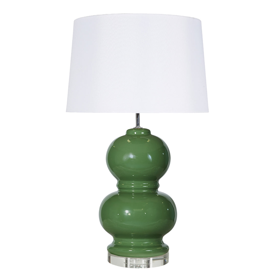 Green table lamp with a white shade on a white background
