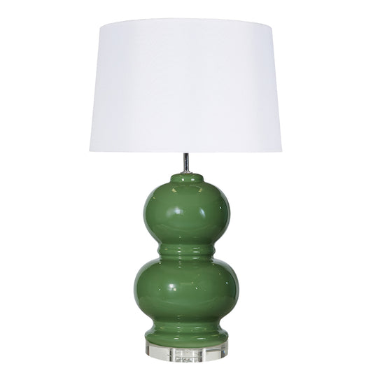 Green table lamp with a white shade on a white background