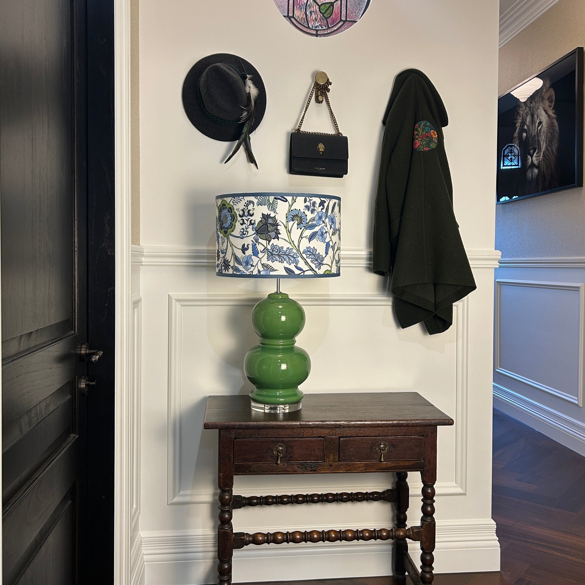 Accent lamp with green and blue chintz pattern lampshade on hallway table