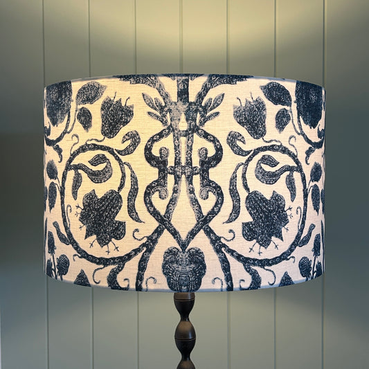 Hamptons style handmade lampshade with blue and white fabric lit up