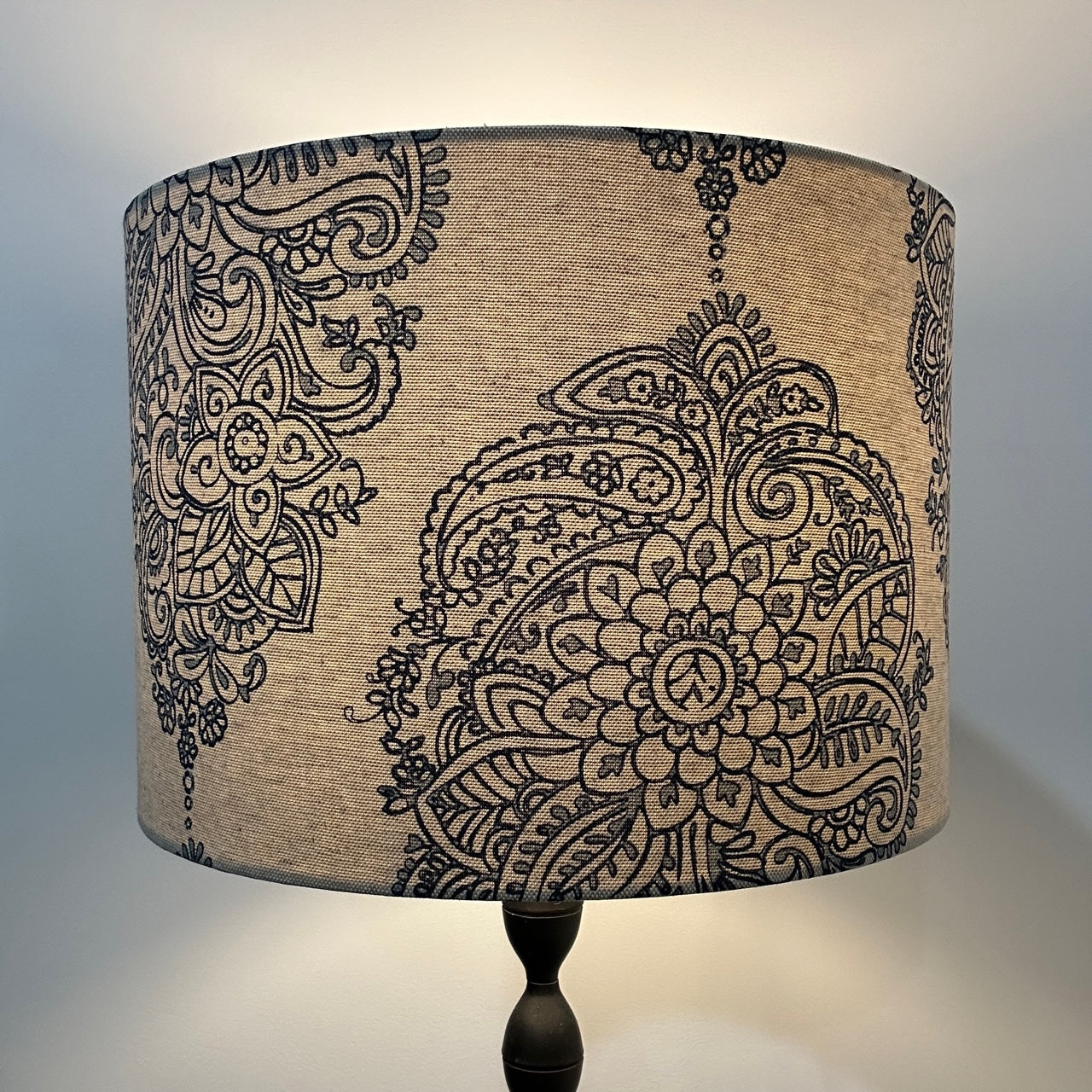 Indian motif blue pattern lampshade, lit up by lamp
