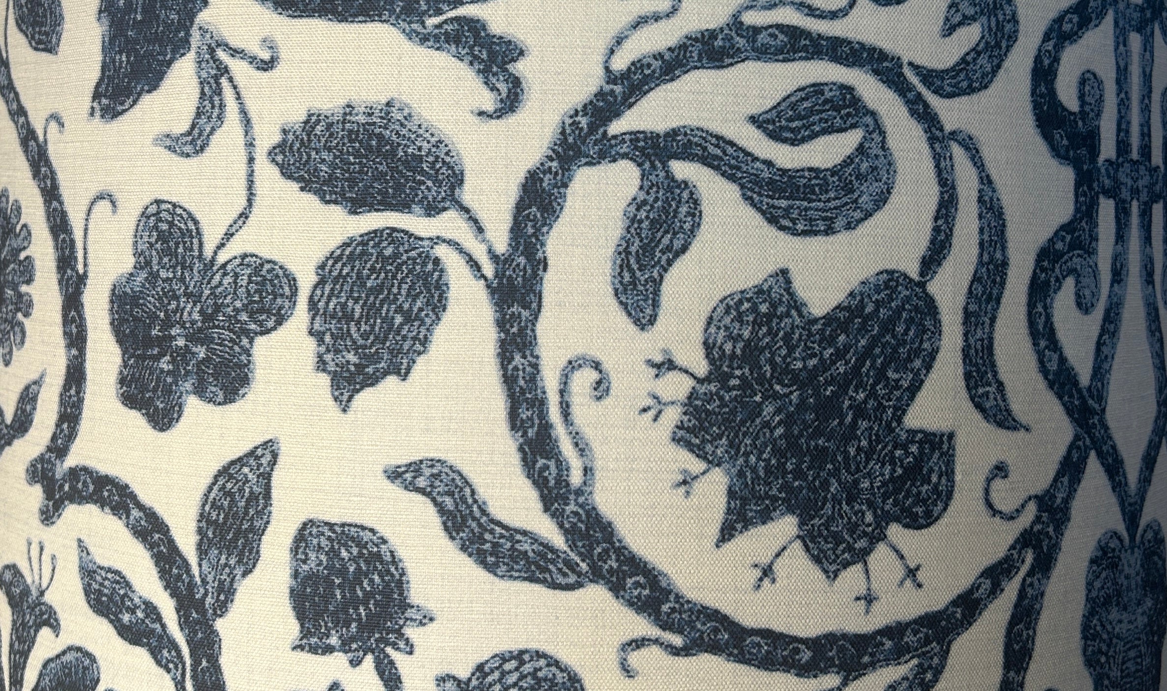 Close-up of a fabric with black floral and leaf pattern on a white background