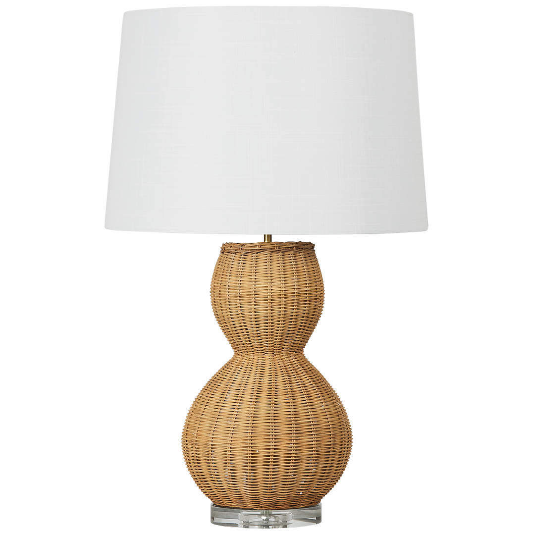 Table lamp with wicker rattan base and white shade on a white background