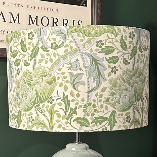 Lampshade with green floral pattern against a dark background